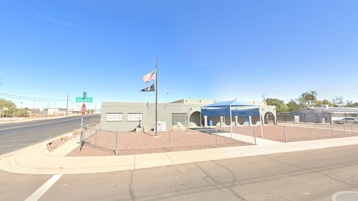American Legion Hazelton-Butler Post 53 building at 402 E Narramore Avenue in Buckeye, Arizona, with US flag and POW/MIA flag flying out front.